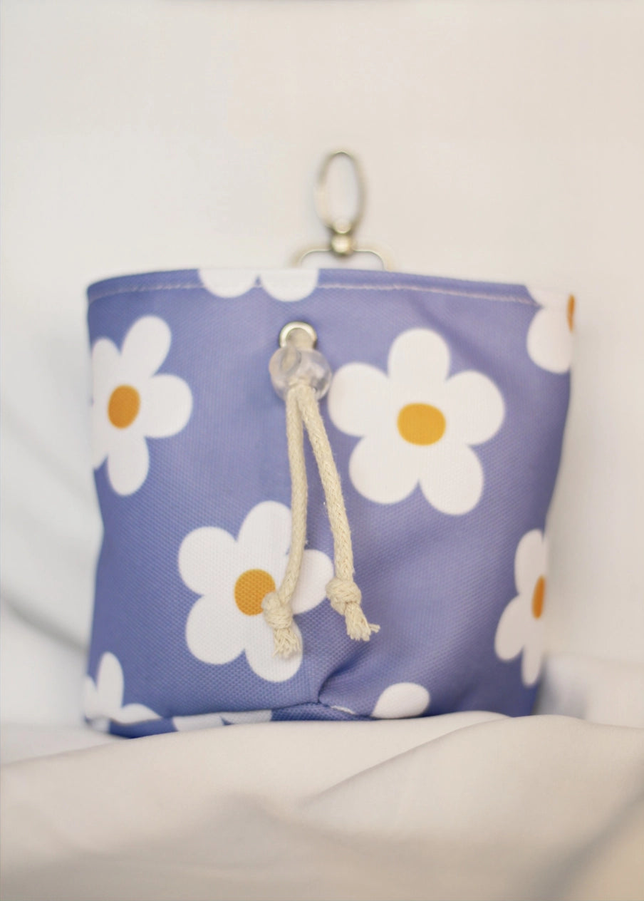 Purple pouch with white daisy patterns on a light background