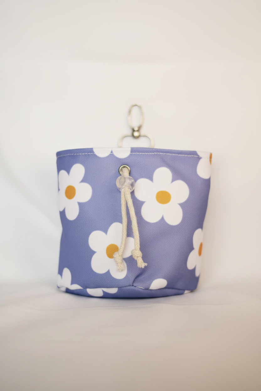 Blue pouch with white daisy pattern on a light gray background