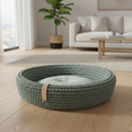 Coco Basket green hand-woven cotton rope dog bed centered on light oak floor in sunlit modern living room